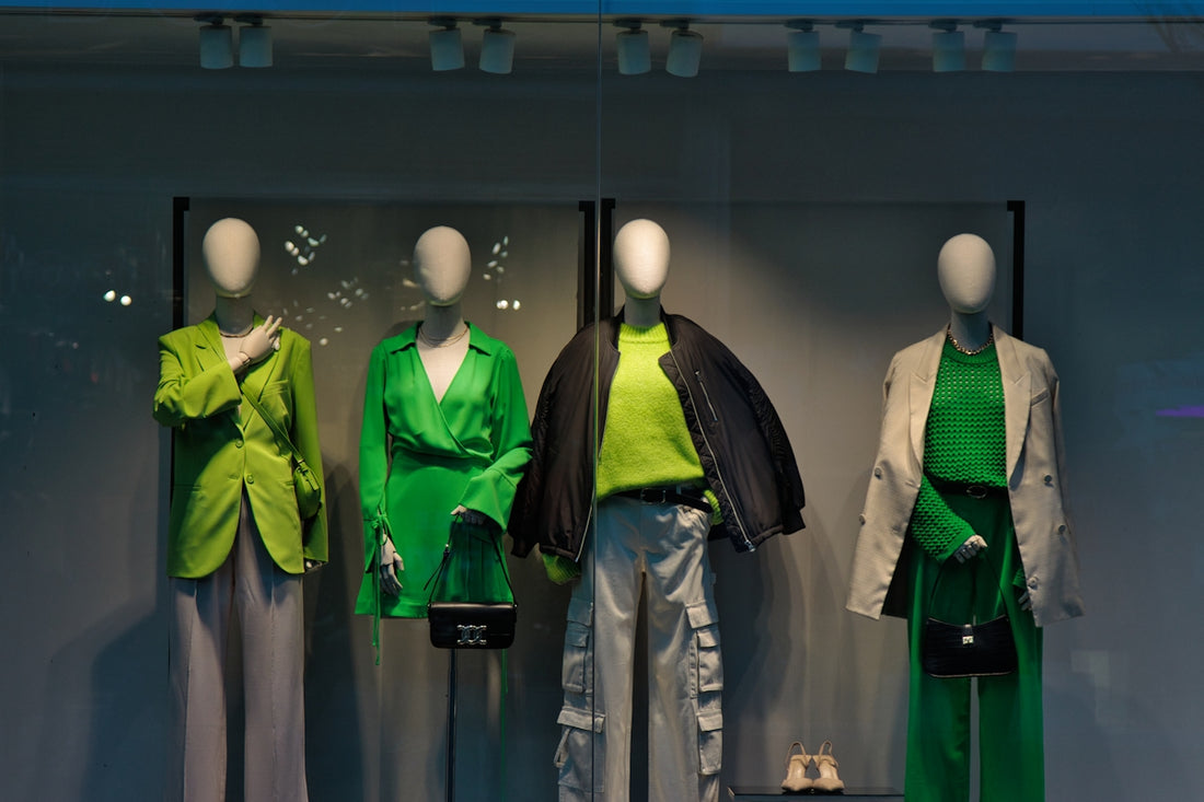 A group of mannequins dressed in green and grey
