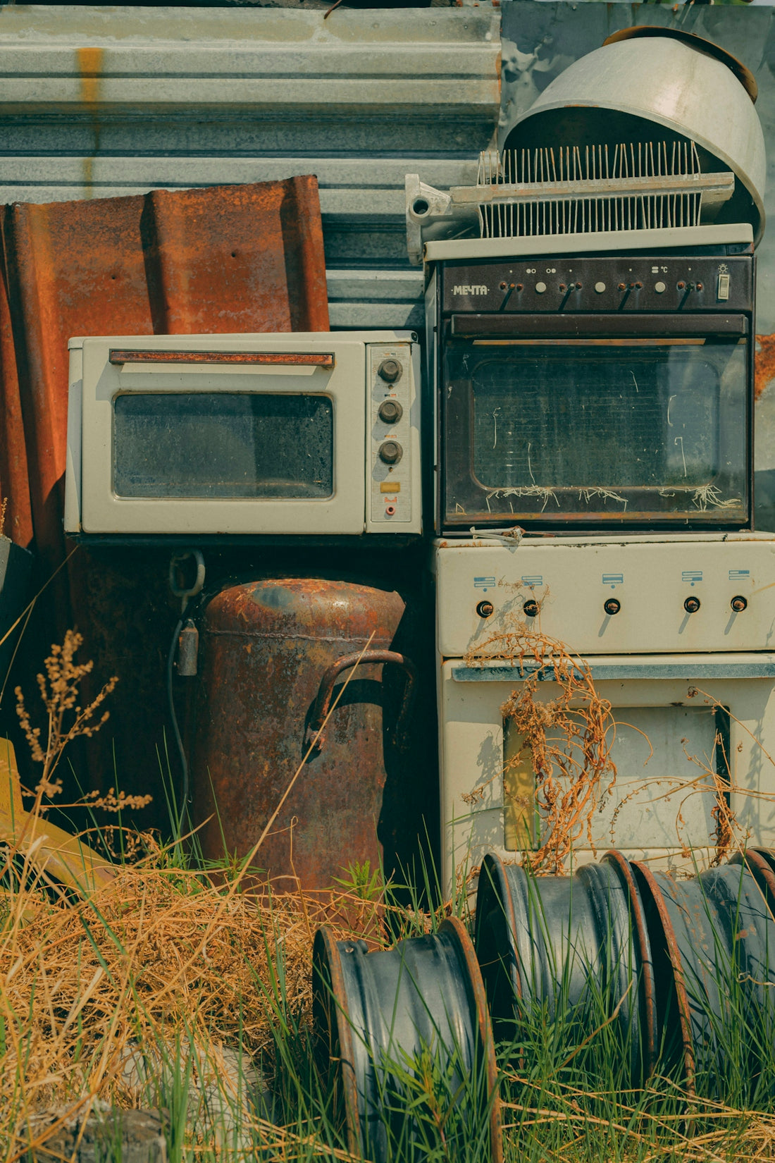 Old appliances and other items sit discarded.