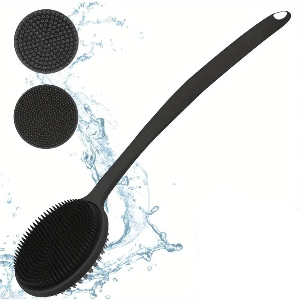 Black massage brush with textured head and long handle on a white background with water splashes.