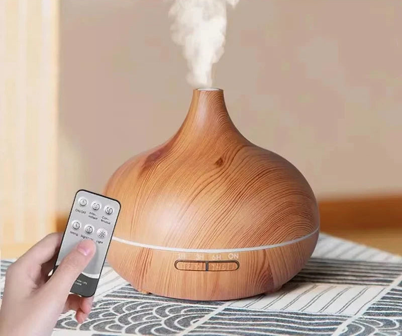 Wooden diffuser with steam coming out and a hand holding a remote control, with a promotional banner at the top.